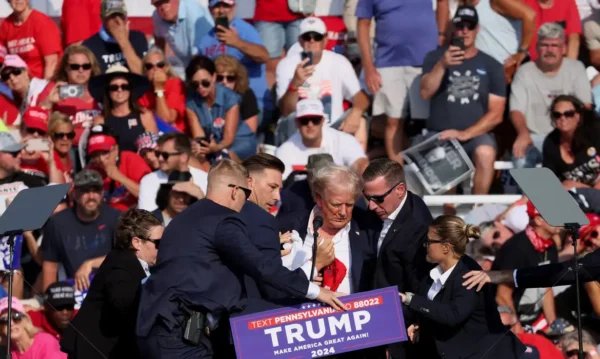 Republican presidential candidate and former U.S. President Donald Trump is assisted by U.S. Secret Service personnel after gunfire rang out during a campaign rally at the Butler Farm Show in Butler, Pennsylvania, U.S., July 13, 2024. REUTERS/Brendan McDermid TPX IMAGES OF THE DAY